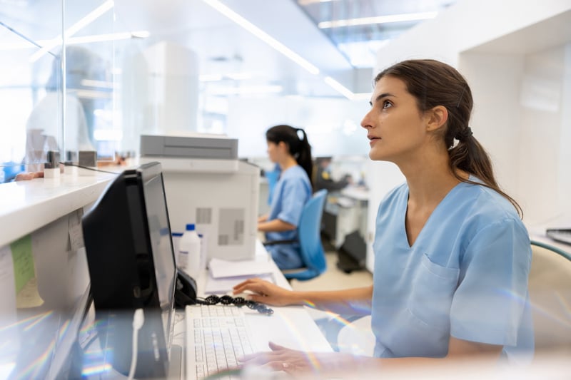 patient checking in while staff verifies insurance 