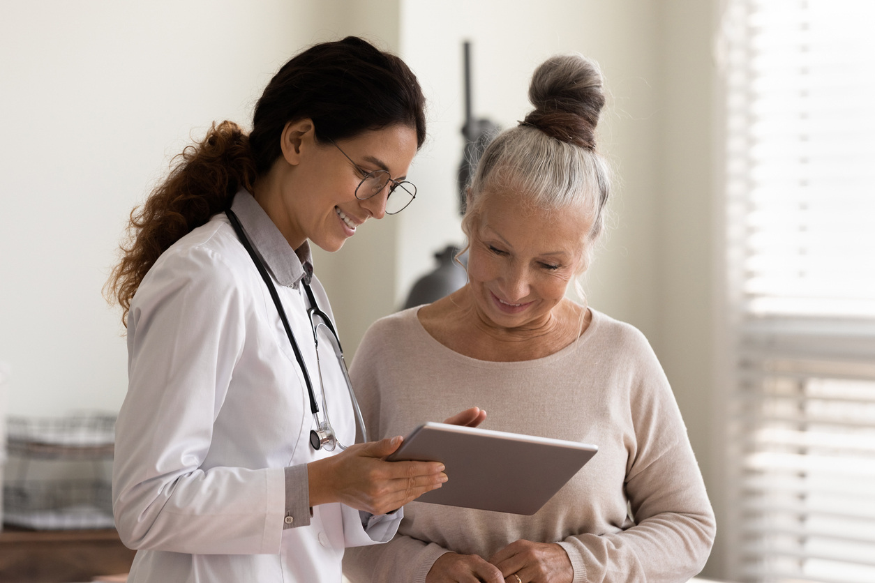 Provider explaining healthcare results to the patient to overcome barriers to patient engagement.